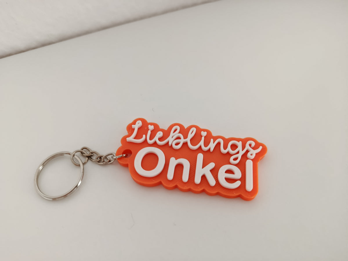Orangefarbener 3D-Schlüsselanhänger mit der Aufschrift Lieblings Onkel und silbernem Schlüsselring