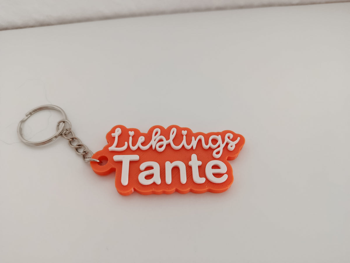 Orangefarbener 3D-Schlüsselanhänger mit der Aufschrift Lieblings Tante und silbernem Schlüsselring